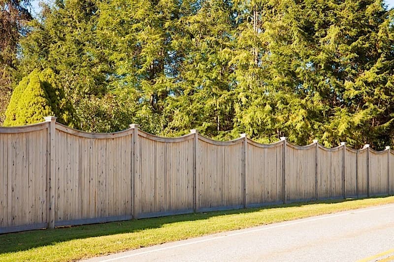 Scalloped privacy cedar fence with custom trim — hand-built in our Southington workshop