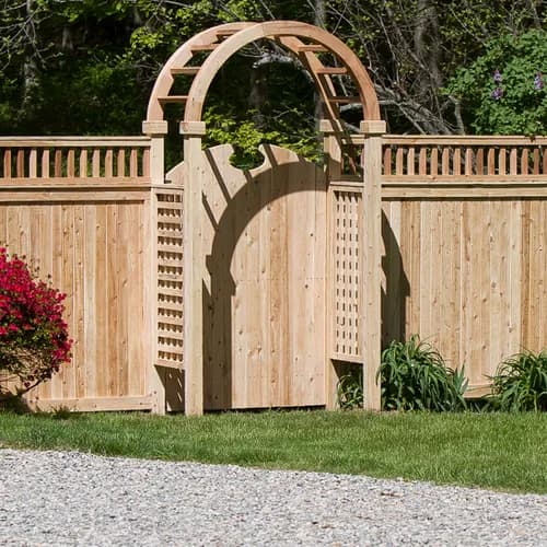 Hand-built cedar privacy fence with arched entry and lattice top at a Connecticut residence