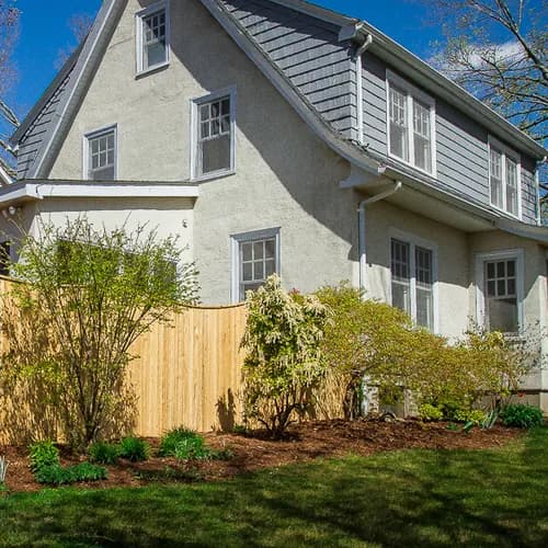 Cedar scalloped privacy fence in front of a Connecticut colonial home